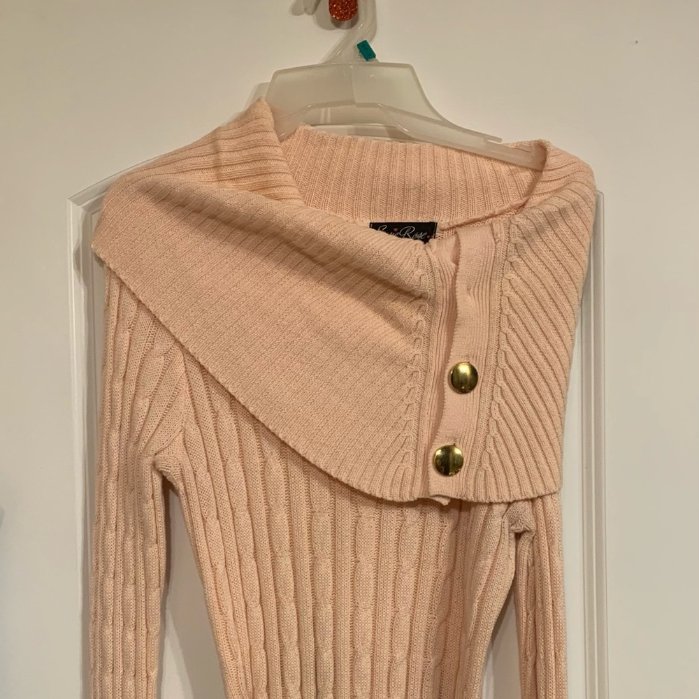 Peach sweater with gold buttons and gold chain belt